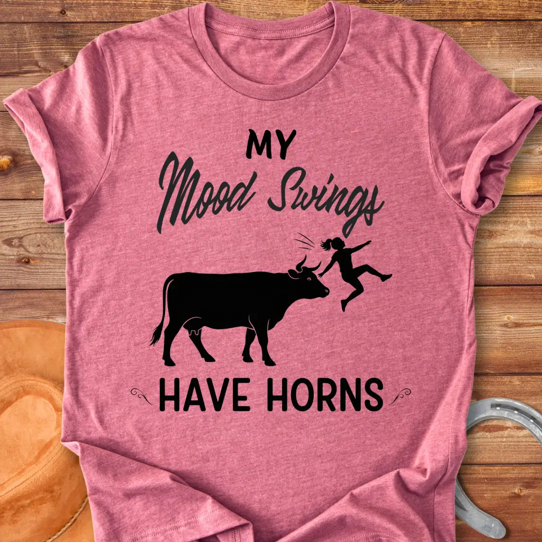 Funny t-shirt design with a cow and the words 'Mood Swings Have Horns'