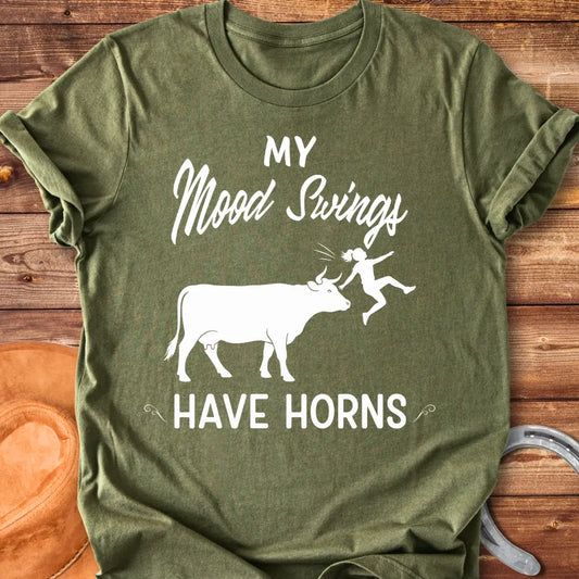 Funny t-shirt design with a cow and the words 'Mood Swings Have Horns'