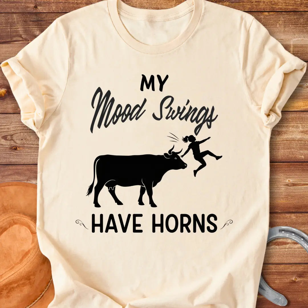 Funny t-shirt design with a cow and the words 'Mood Swings Have Horns'