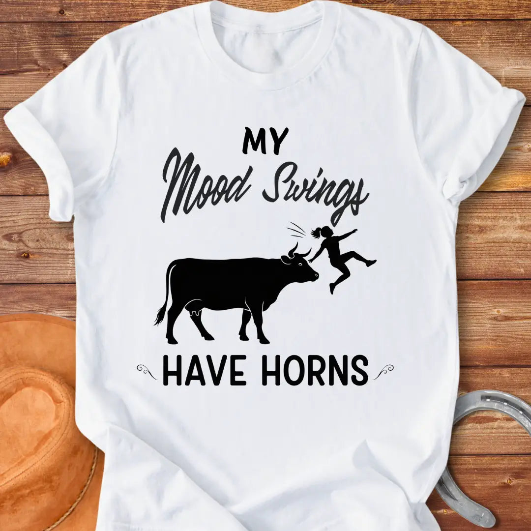 Funny t-shirt design with a cow and the words 'Mood Swings Have Horns'