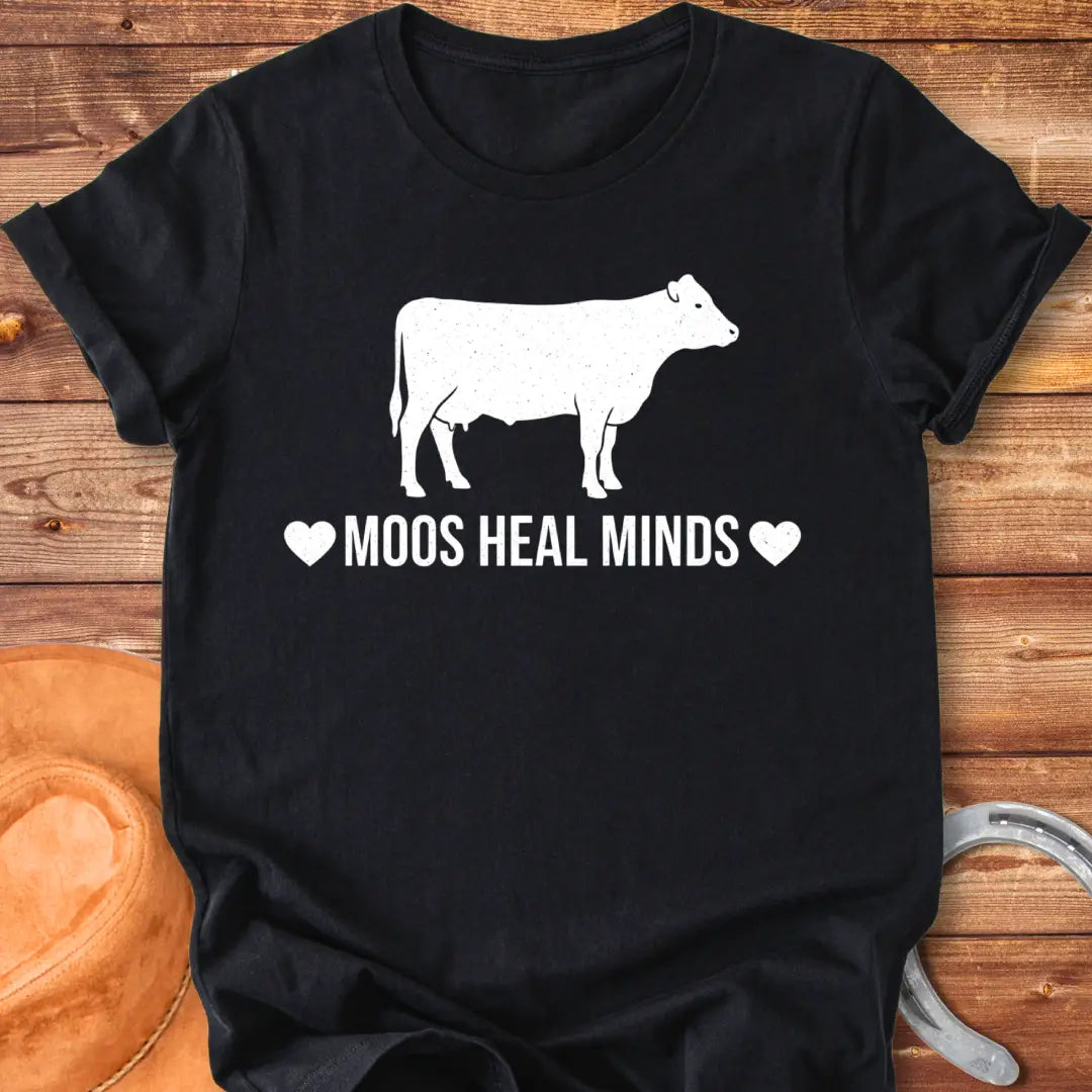 Moos Heal Minds T-shirt featuring a cow silhouette and the phrase 'Moos Heal Minds'
