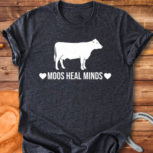 Moos Heal Minds T-shirt featuring a cow silhouette and the phrase 'Moos Heal Minds'