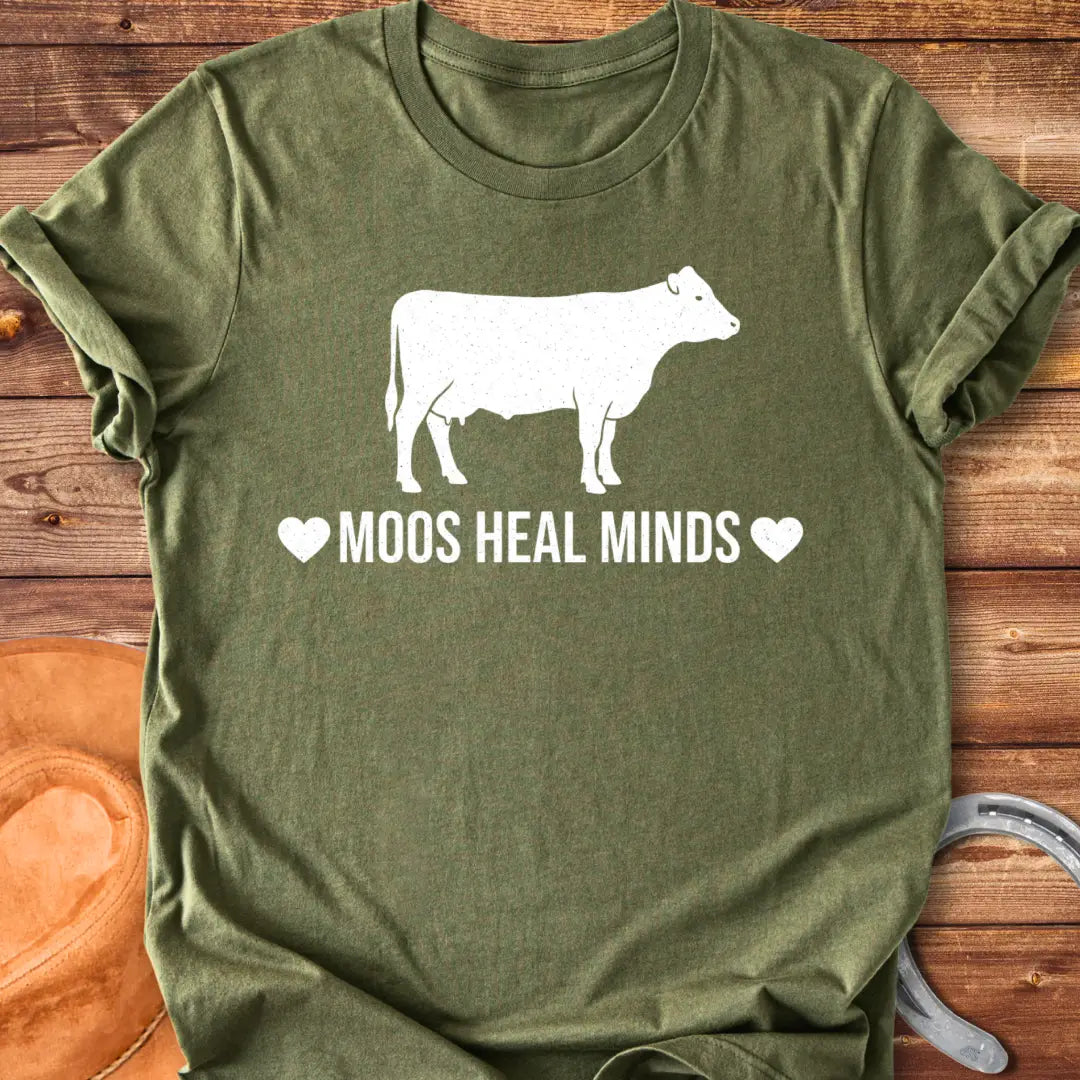Moos Heal Minds T-shirt featuring a cow silhouette and the phrase 'Moos Heal Minds'