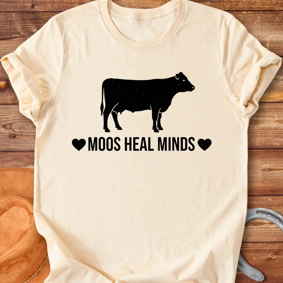 Moos Heal Minds T-shirt featuring a cow silhouette and the phrase 'Moos Heal Minds'