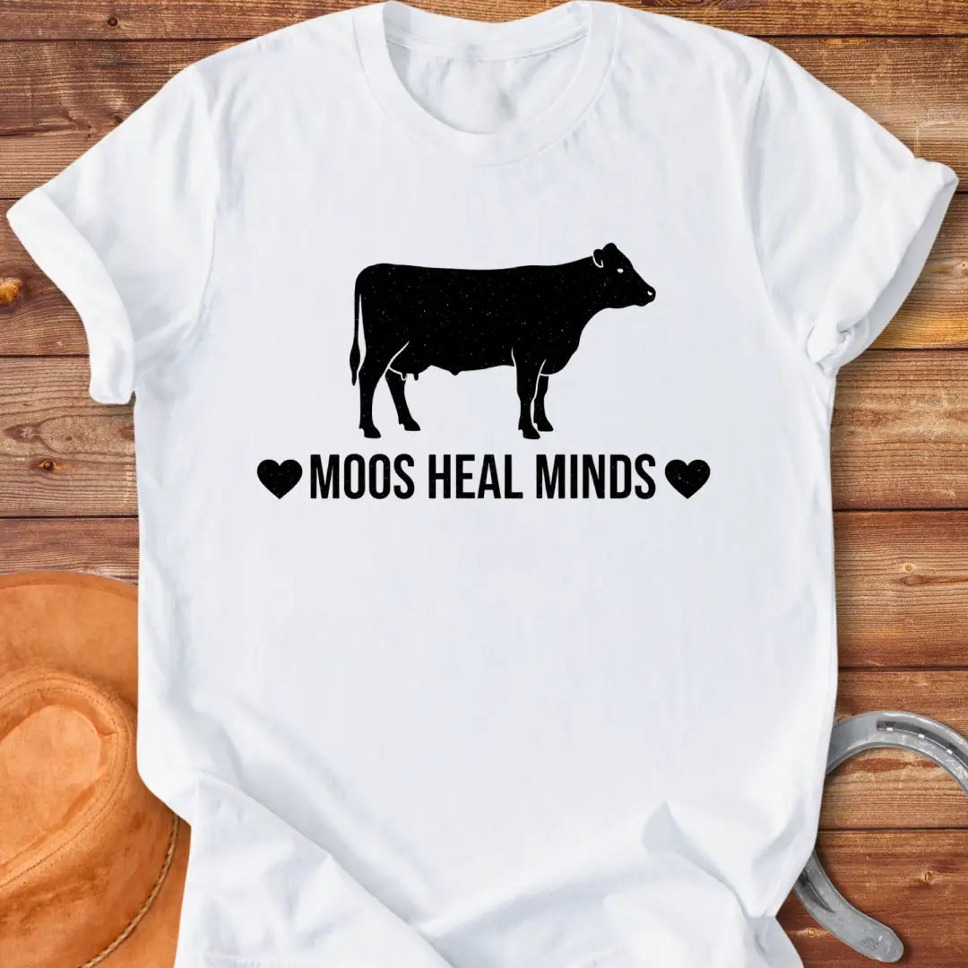 Moos Heal Minds T-shirt featuring a cow silhouette and the phrase 'Moos Heal Minds'