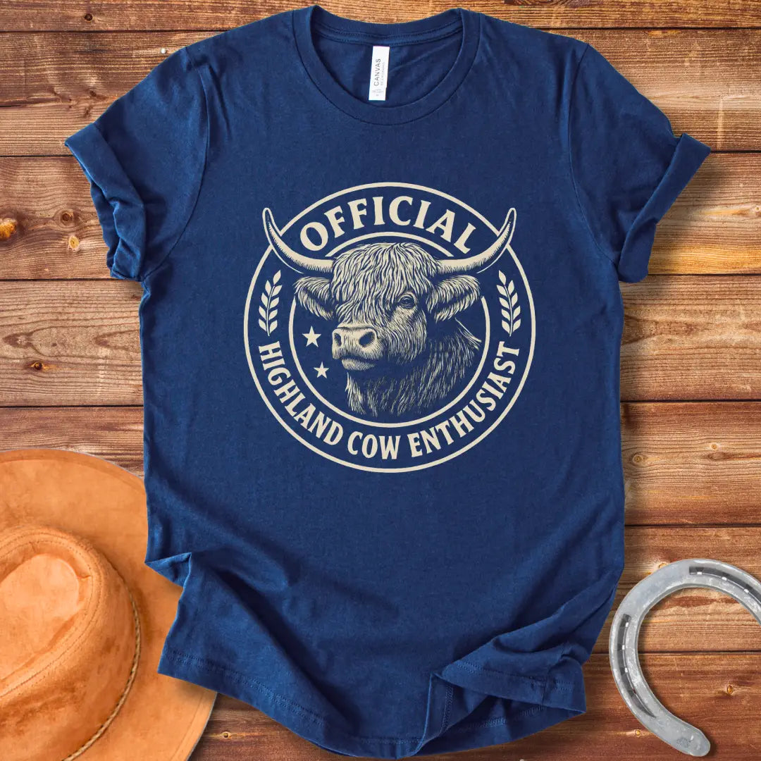 Official Highland Cow Enthusiast T-Shirt design featuring a detailed illustration of a Highland cow's head within a circular emblem with the words 'Official Highland Cow Enthusiast' written on it.