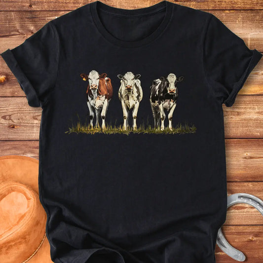 Illustration of three cows in a pastoral setting, featuring brown, white, and black and white cows standing in a field of grass.