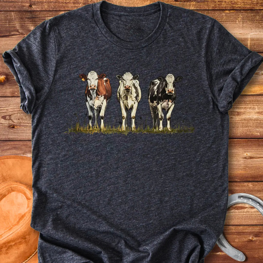 Illustration of three cows in a pastoral setting, featuring brown, white, and black and white cows standing in a field of grass.