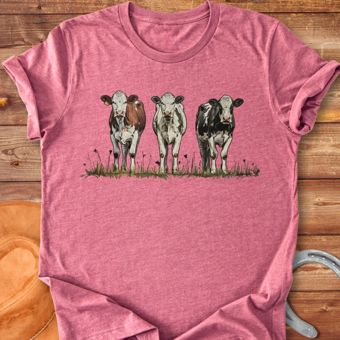 Illustration of three cows in a pastoral setting, featuring brown, white, and black and white cows standing in a field of grass.