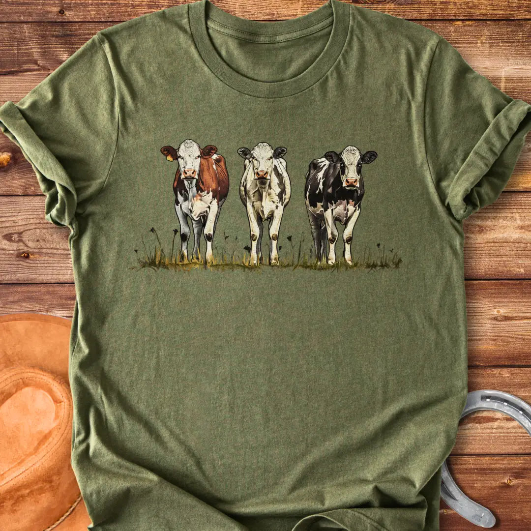 Illustration of three cows in a pastoral setting, featuring brown, white, and black and white cows standing in a field of grass.