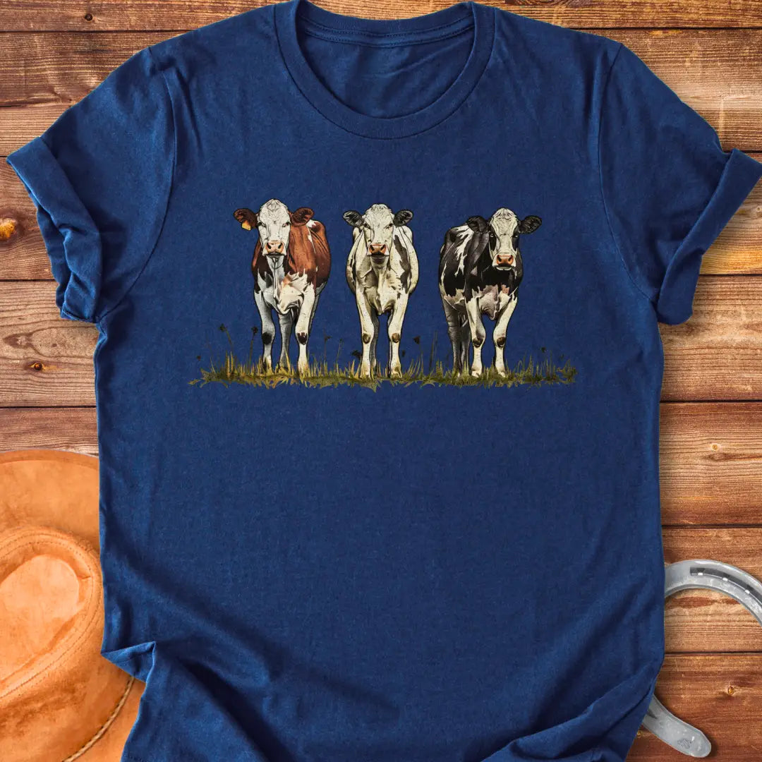 Illustration of three cows in a pastoral setting, featuring brown, white, and black and white cows standing in a field of grass.