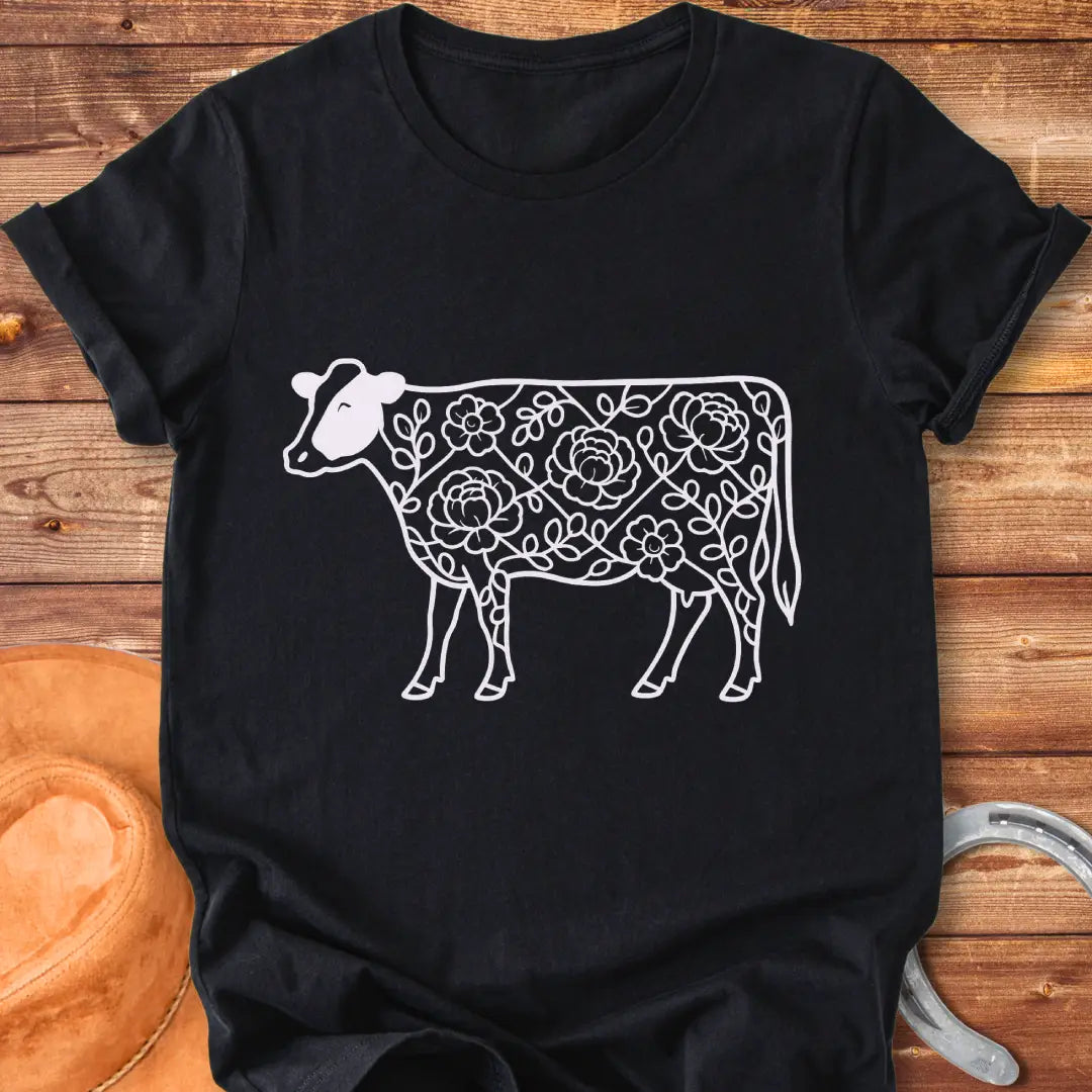 Silhouette of a holstein cow filled with peony flowers and eucalyptus leaves, in green outline.