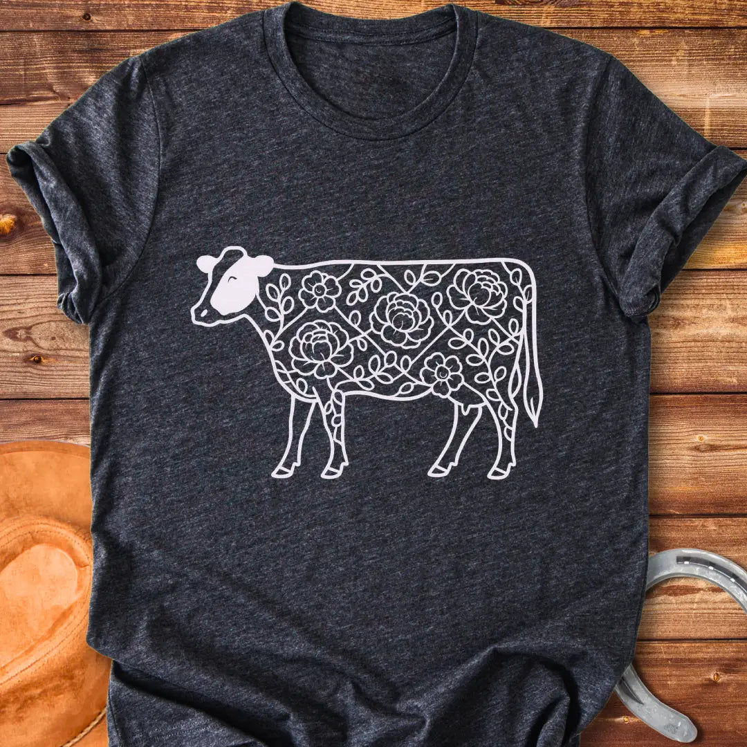 Silhouette of a holstein cow filled with peony flowers and eucalyptus leaves, in green outline.