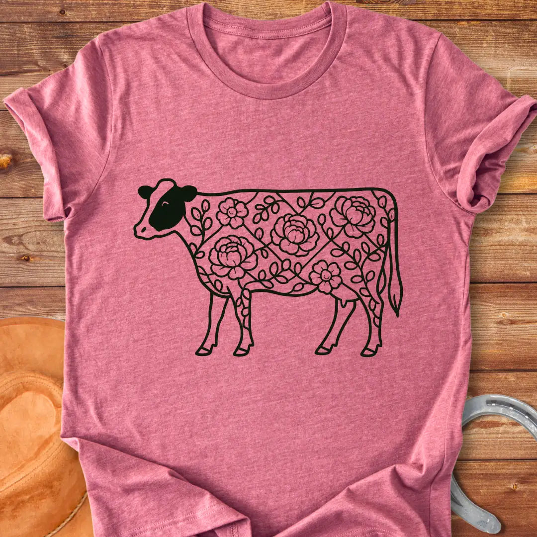 Silhouette of a holstein cow filled with peony flowers and eucalyptus leaves, in green outline.