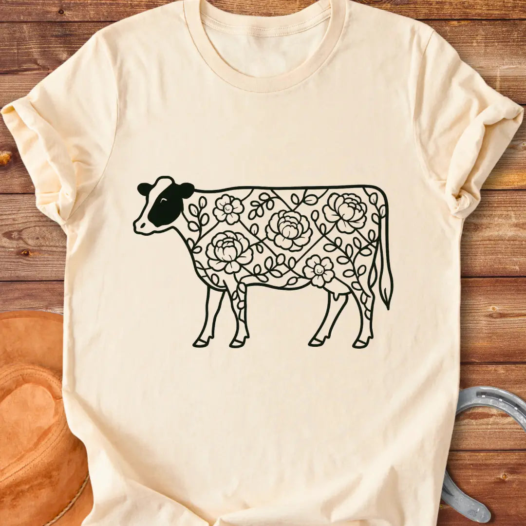 Silhouette of a holstein cow filled with peony flowers and eucalyptus leaves, in green outline.