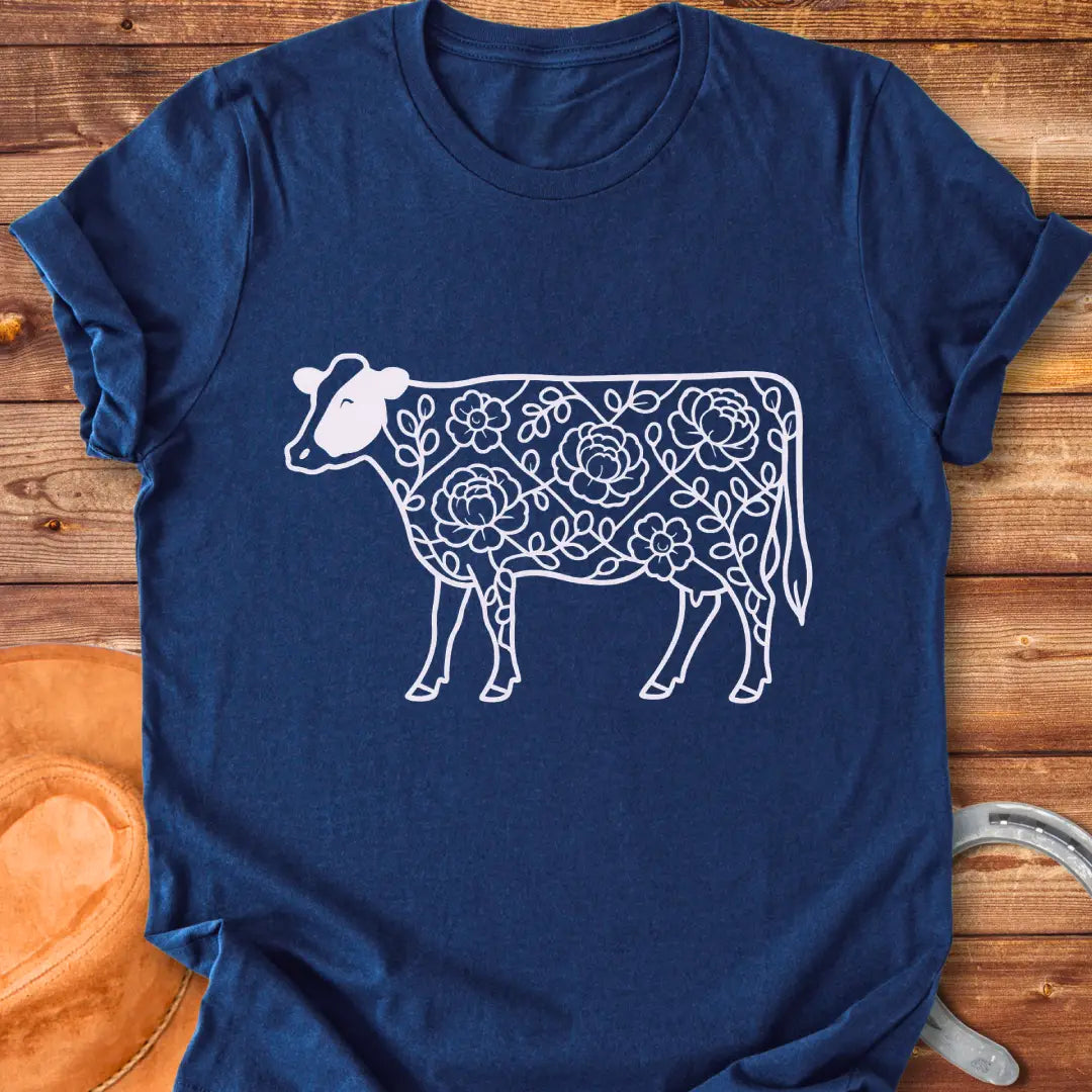 Silhouette of a holstein cow filled with peony flowers and eucalyptus leaves, in green outline.
