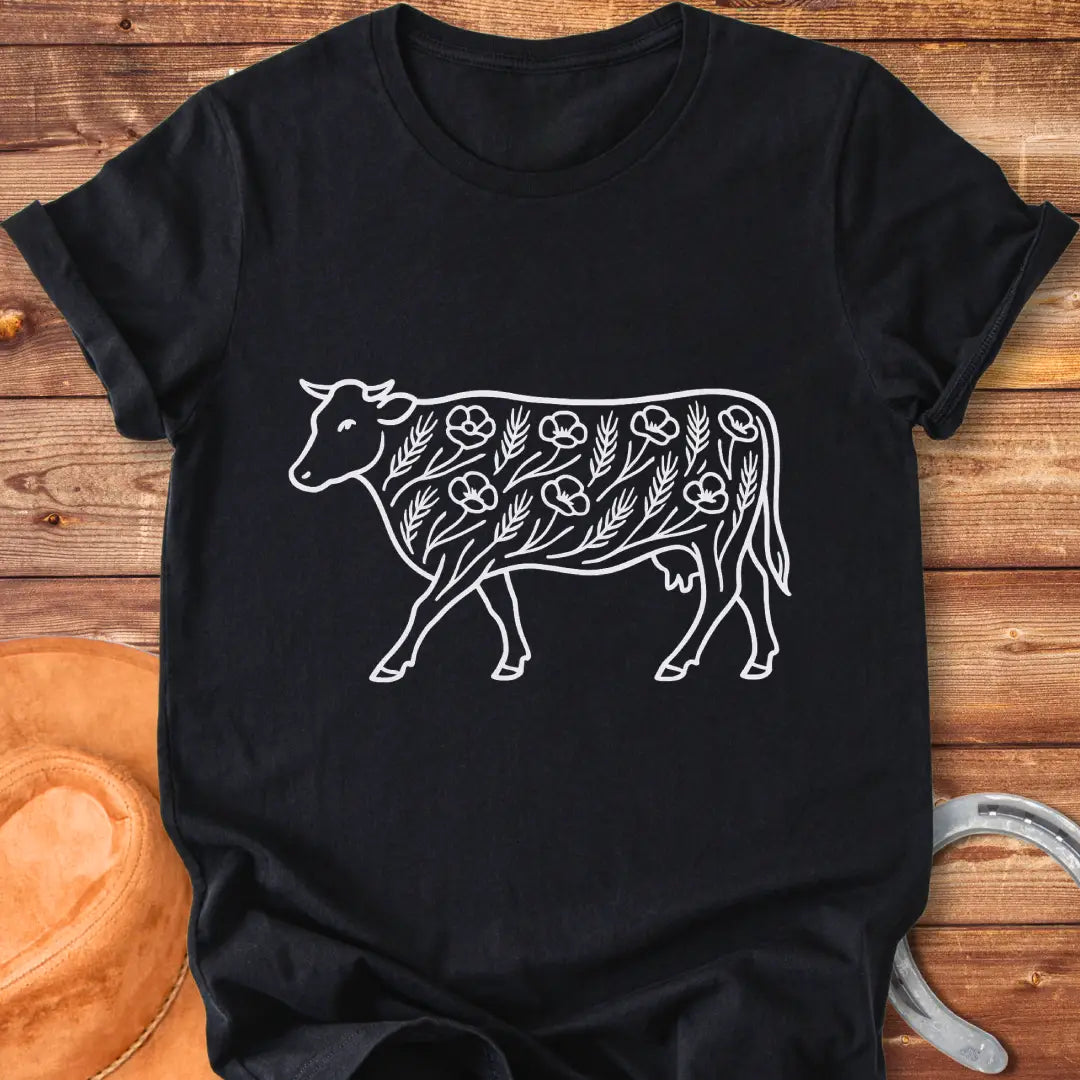 Line art illustration of a cow adorned with poppies and wheat stalks, representing a countryside theme.