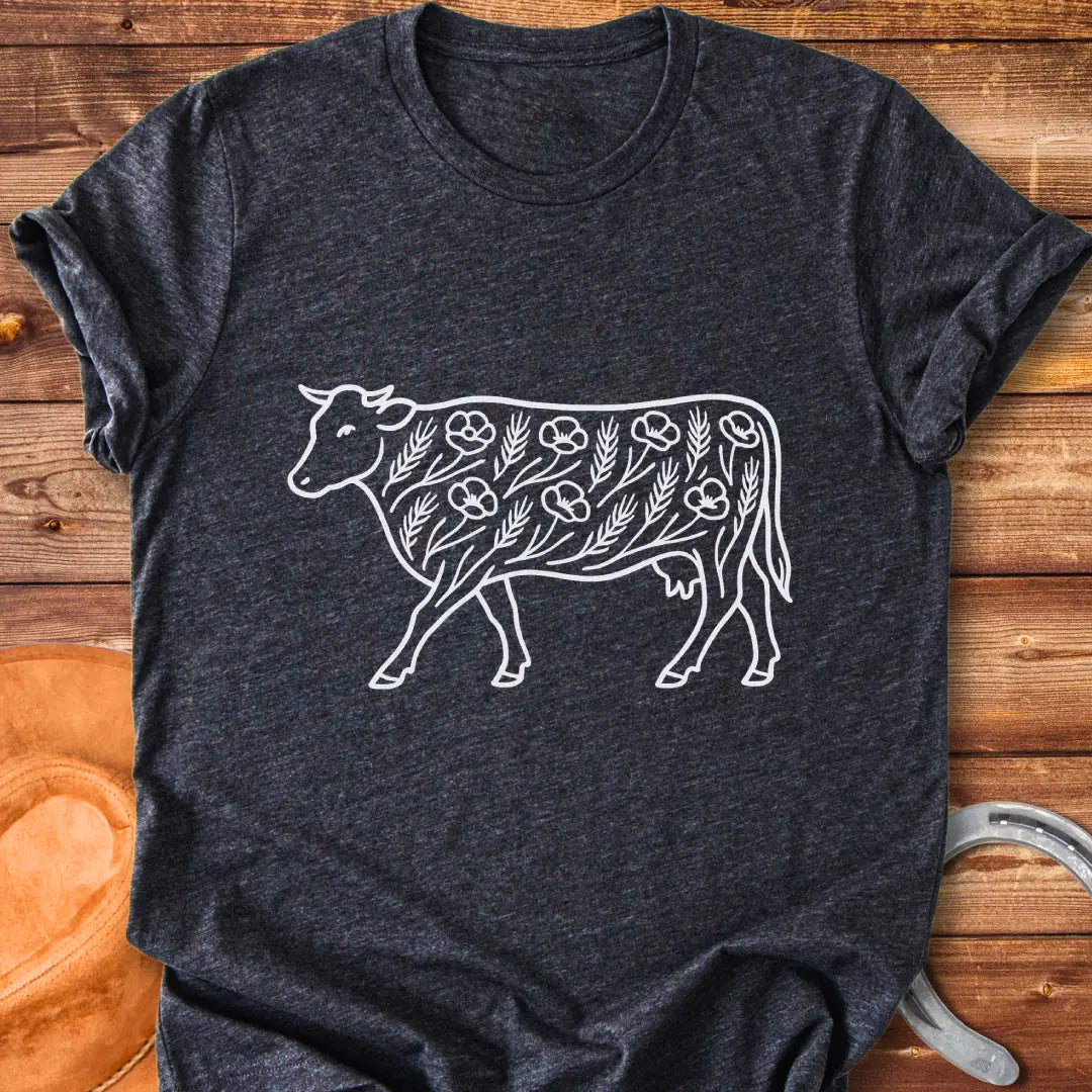 Line art illustration of a cow adorned with poppies and wheat stalks, representing a countryside theme.