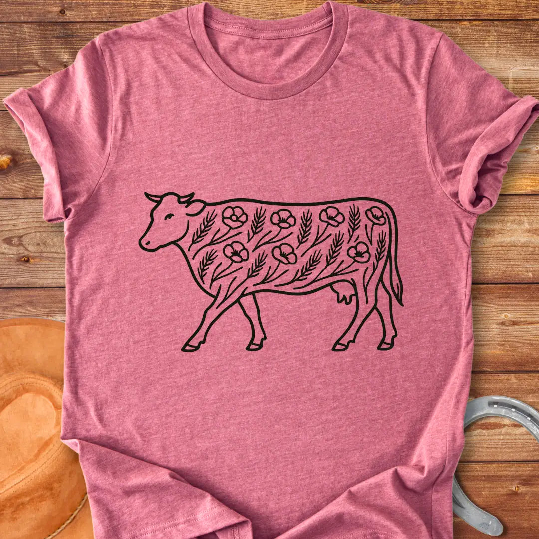 Line art illustration of a cow adorned with poppies and wheat stalks, representing a countryside theme.
