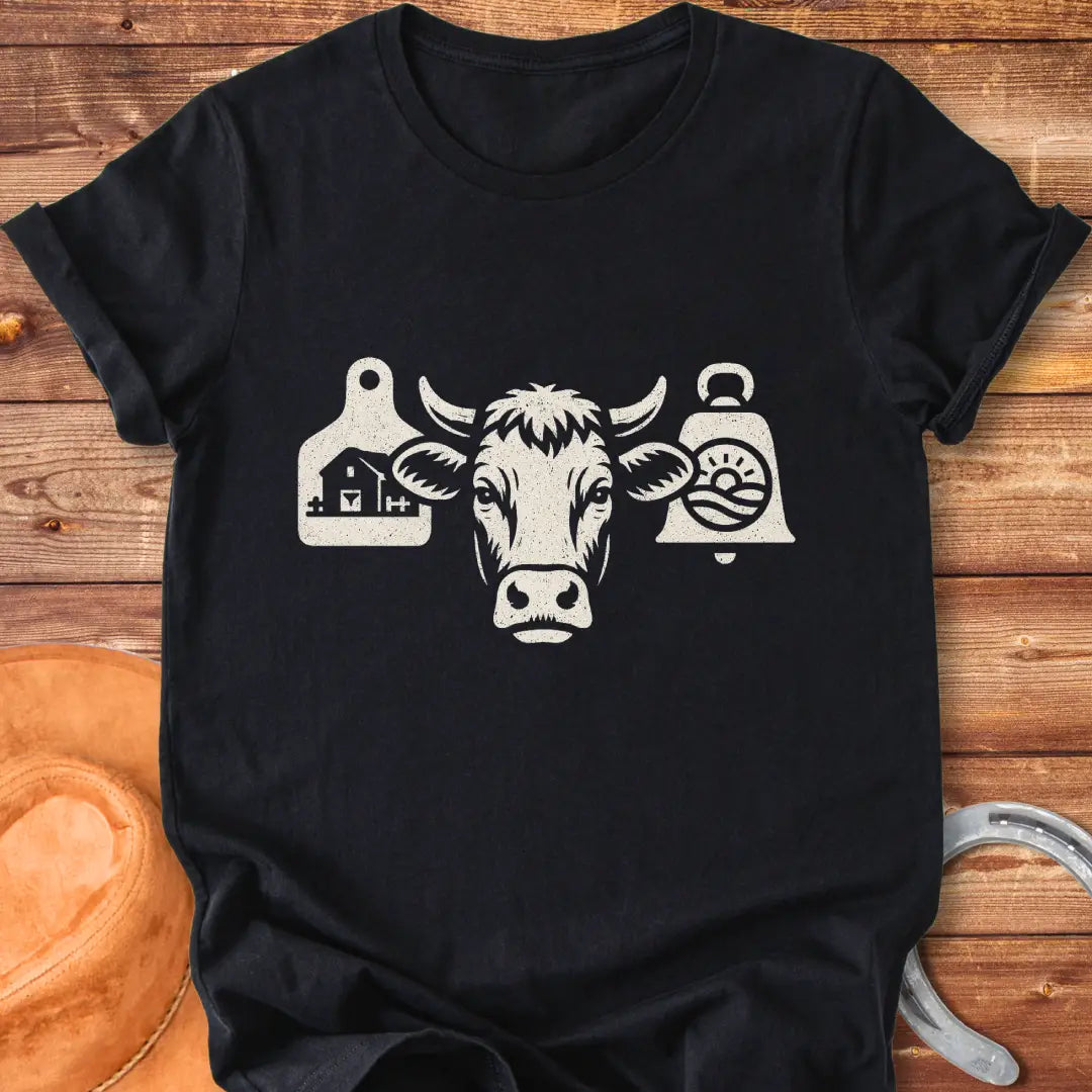 Black and white silhouette of a cow's head with bell tags, one showing a farm and the other with a landscape with sun