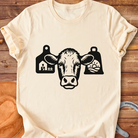 Black and white silhouette of a cow's head with bell tags, one showing a farm and the other with a landscape with sun