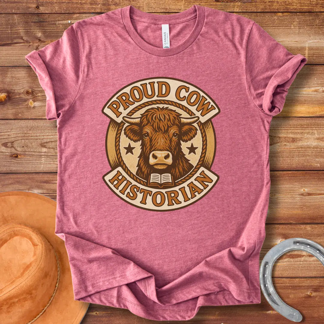 Proud Cow Historian T-Shirt featuring a highland cow, books, and stars.