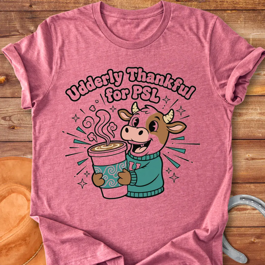 Cartoon cow holding a PSL cup, text reads 'Udderly Thankful for PSL', Cow Lovers Clothing t-shirt design