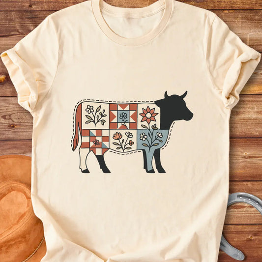 Quilt Blooms T-Shirt featuring a cow silhouette with a patchwork quilt pattern and floral details.