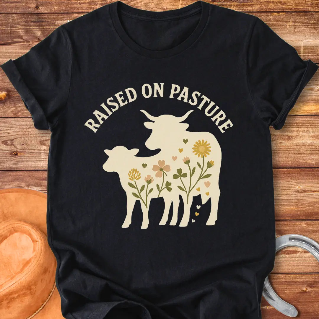 Raised On Pasture T-Shirt featuring a cow silhouette filled with flowers and hearts.