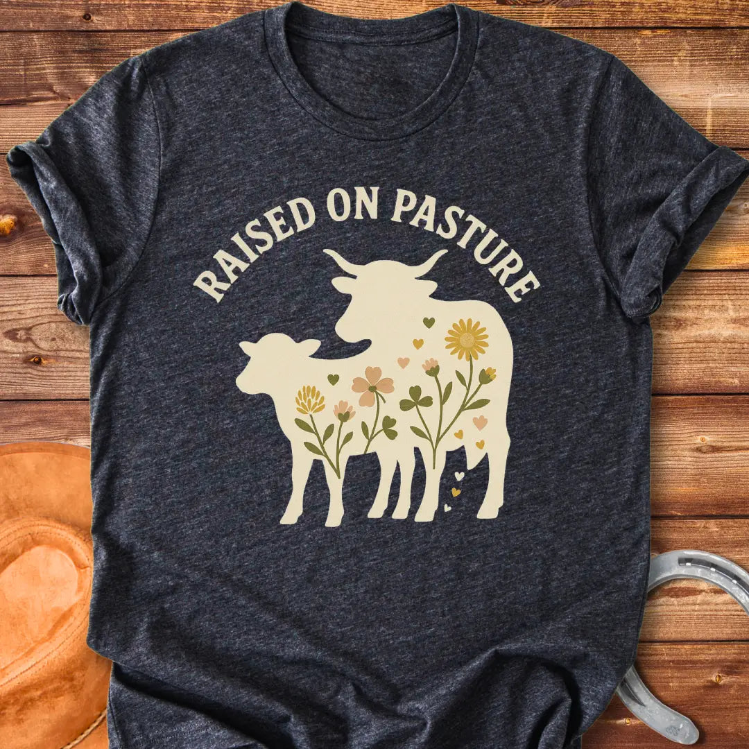 Raised On Pasture T-Shirt featuring a cow silhouette filled with flowers and hearts.