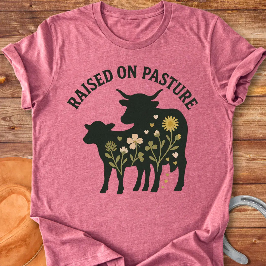 Raised On Pasture T-Shirt featuring a cow silhouette filled with flowers and hearts.