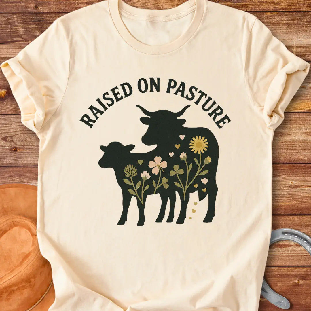 Raised On Pasture T-Shirt featuring a cow silhouette filled with flowers and hearts.