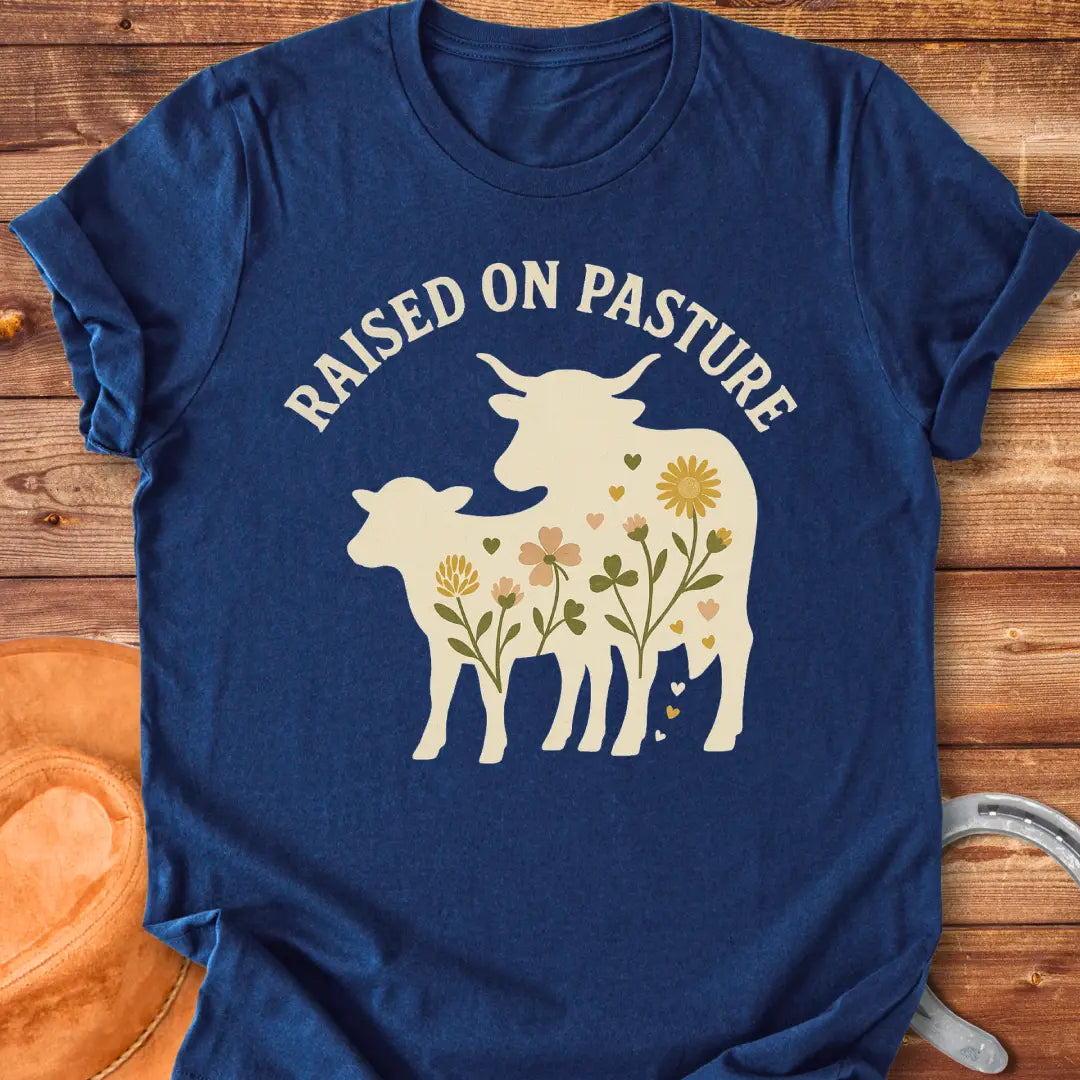 Raised On Pasture T-Shirt featuring a cow silhouette filled with flowers and hearts.