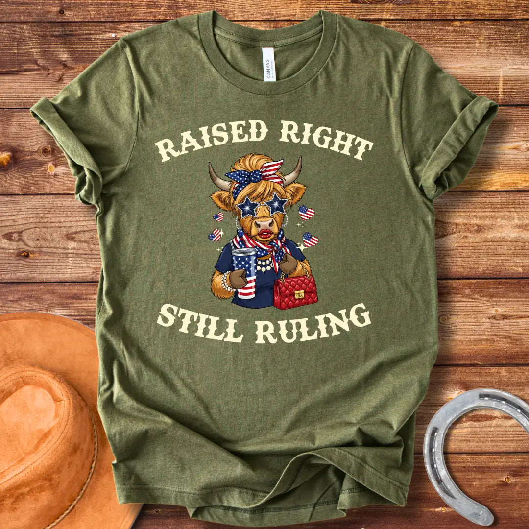 Stylish cow wearing star sunglasses and a patriotic scarf, holding a drink and purse, with the text 'Raised Right Still Ruling' above.