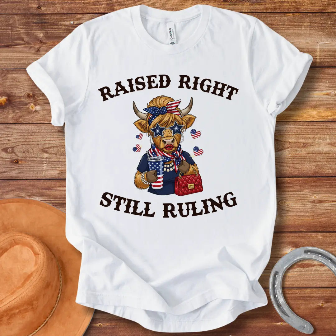 Stylish cow wearing star sunglasses and a patriotic scarf, holding a drink and purse, with the text 'Raised Right Still Ruling' above.