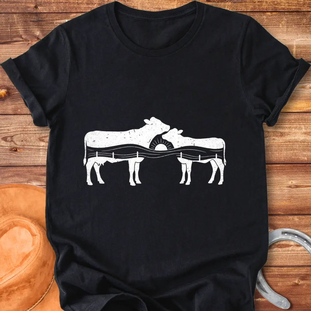 Silhouette design of a cow family with a sunset over a fence