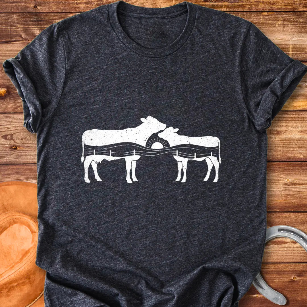 Silhouette design of a cow family with a sunset over a fence
