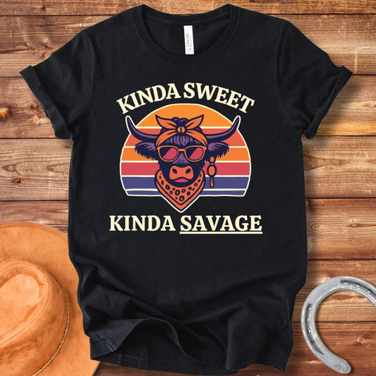Retro t-shirt with a cool cow graphic, sunglasses, bandana, and the words 'Kinda Sweet, Kinda Savage' in a sunset background.