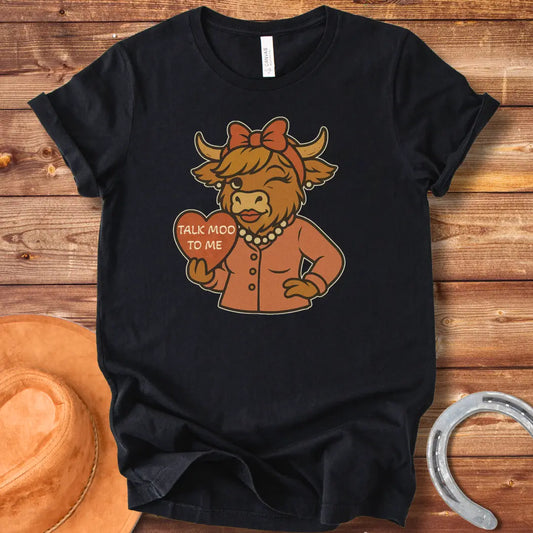 Talk Moo To Me T-Shirt design featuring a stylish winking cow holding a heart