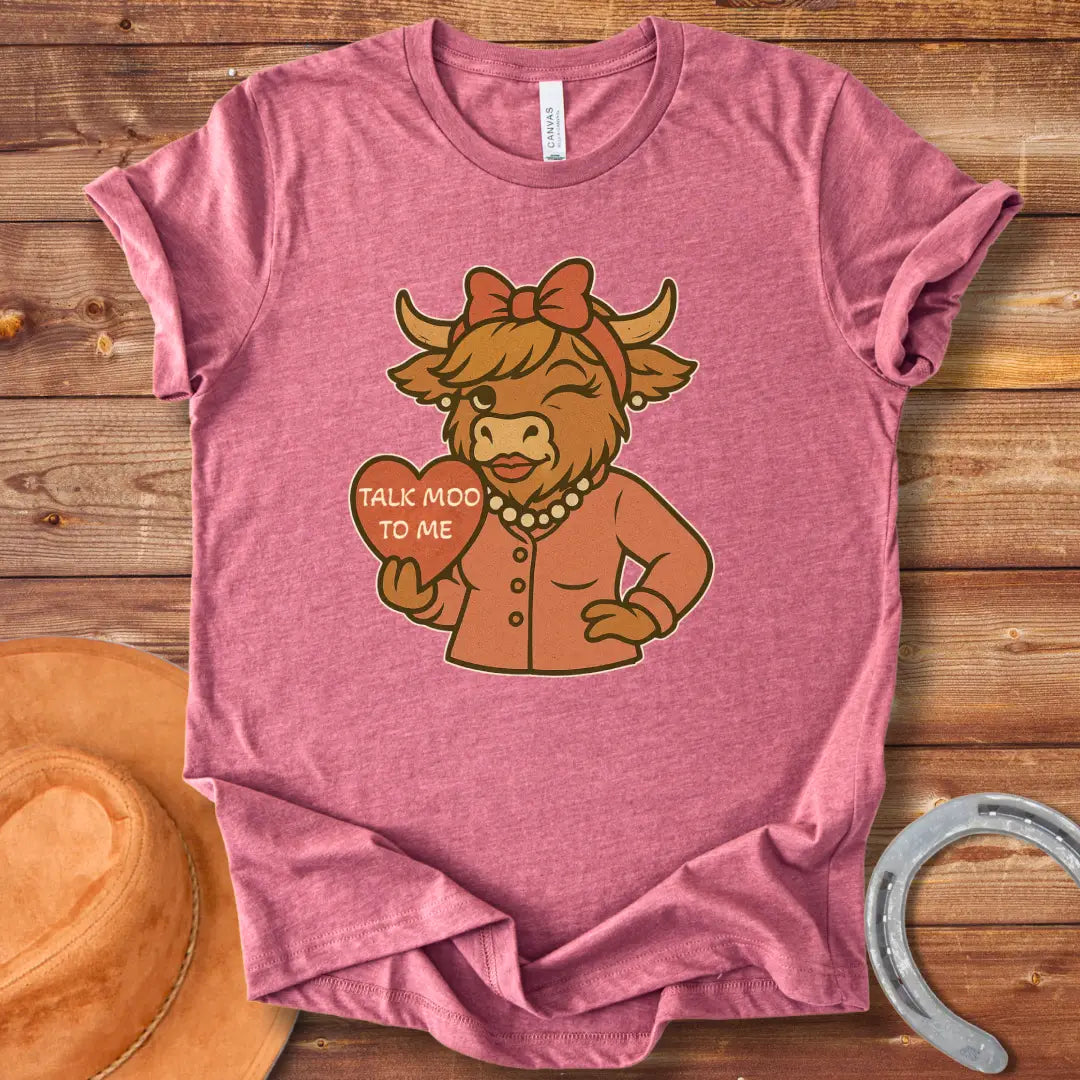 Talk Moo To Me T-Shirt design featuring a stylish winking cow holding a heart