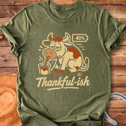 Tired cow drinking coffee, the words Thankful-ish underneath. A fun and relatable design for cow lovers.