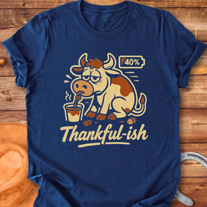 Tired cow drinking coffee, the words Thankful-ish underneath. A fun and relatable design for cow lovers.