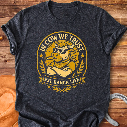Trust Cow Badge T-Shirt featuring a cool cow wearing sunglasses and a bandana with the text 'In Cow We Trust' and 'Est. Ranch Life.'