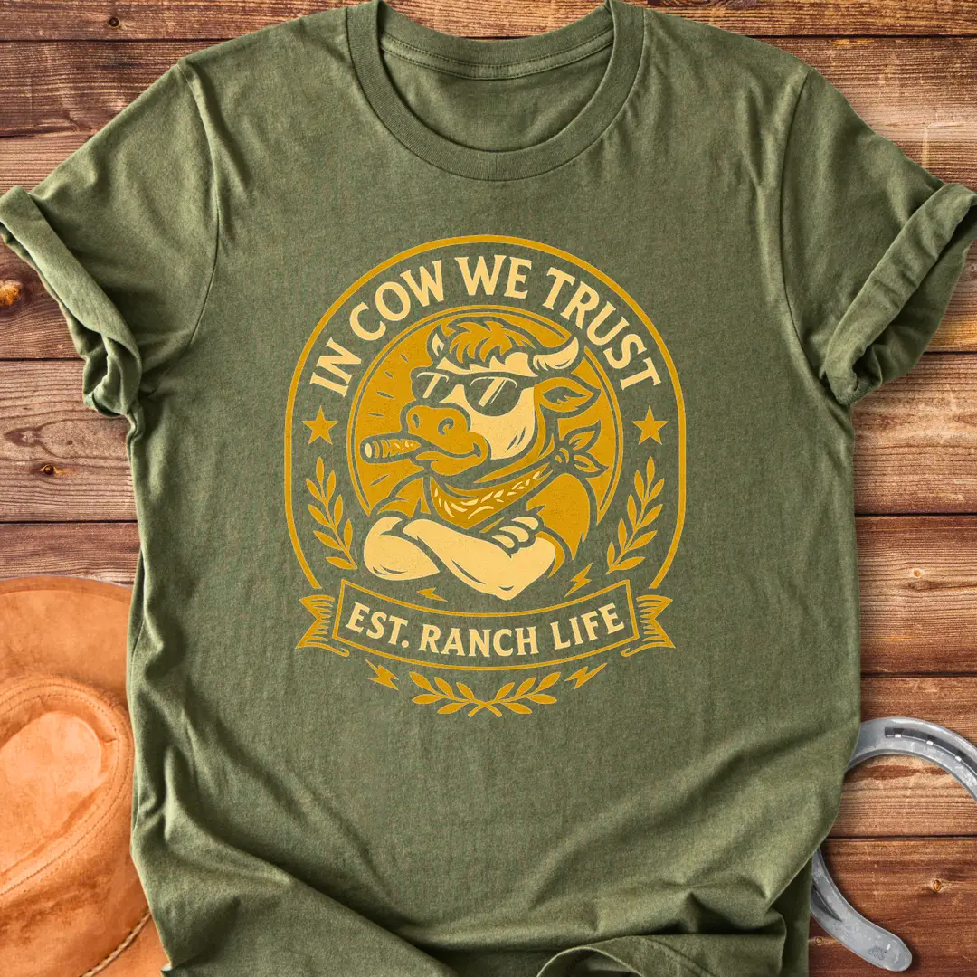 Trust Cow Badge T-Shirt featuring a cool cow wearing sunglasses and a bandana with the text 'In Cow We Trust' and 'Est. Ranch Life.'