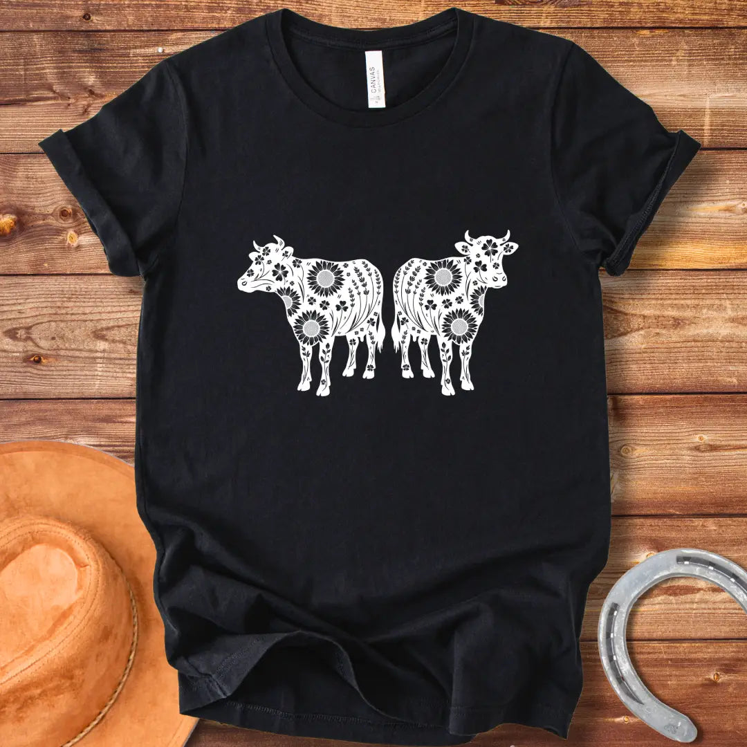 Twin floral cows t-shirt design featuring two cow silhouettes filled with sunflowers and floral patterns