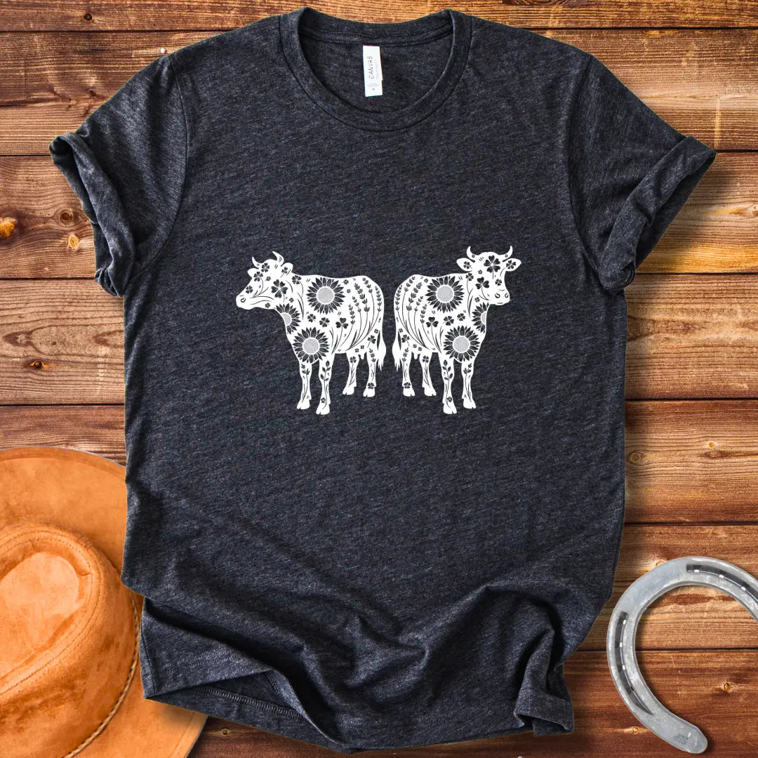 Twin floral cows t-shirt design featuring two cow silhouettes filled with sunflowers and floral patterns