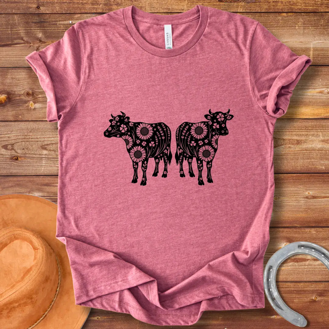 Twin floral cows t-shirt design featuring two cow silhouettes filled with sunflowers and floral patterns