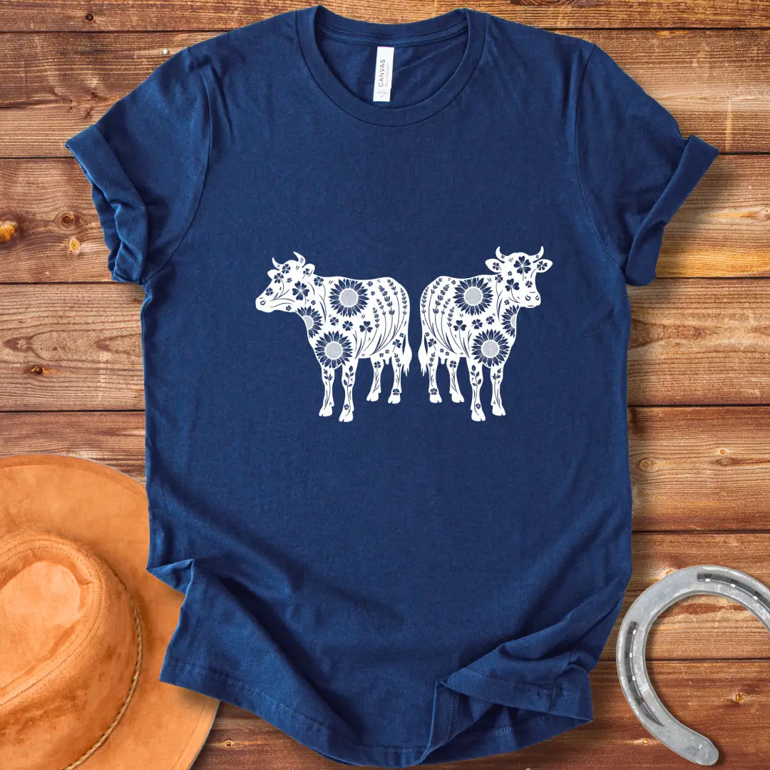 Twin floral cows t-shirt design featuring two cow silhouettes filled with sunflowers and floral patterns