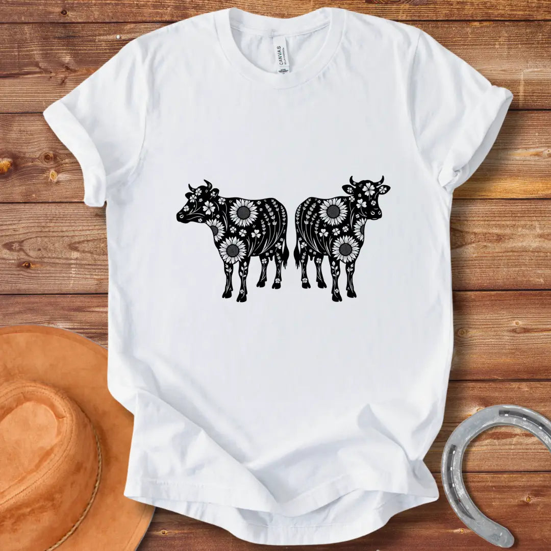 Twin floral cows t-shirt design featuring two cow silhouettes filled with sunflowers and floral patterns