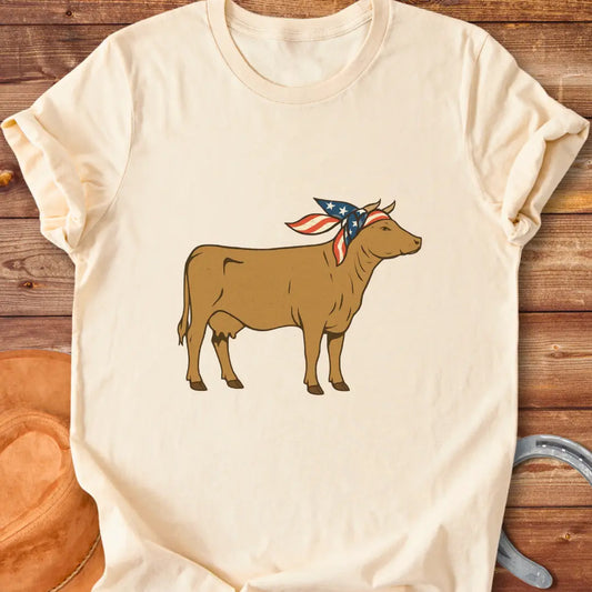 USA Cowgirl T-Shirt featuring a brown cow wearing an American flag bandana, patriotic cow design